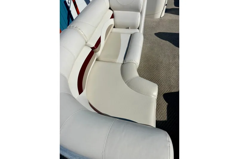 Slide: The Image of White leather seating on 2007 Crest LE 2270 boat, featuring red accents and textured flooring. - 29