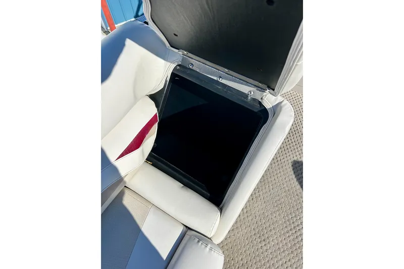 Slide: The Image of Open storage compartment in 2007 Crest LE 2270 boat seat, featuring white upholstery. - 31