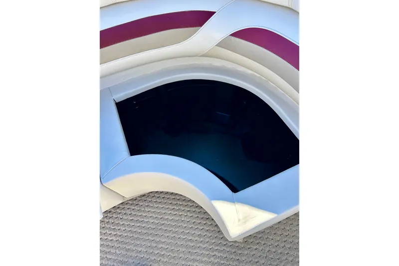 Slide: The Image of 2007 Crest LE 2270 boat seating with storage compartment, featuring white and maroon upholstery. - 34