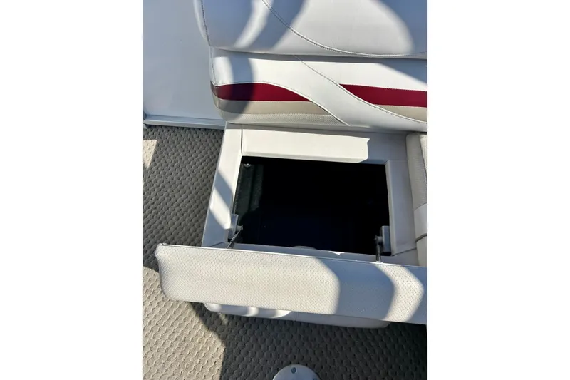 Slide: The Image of Open storage compartment in 2007 Crest LE 2270 boat seat, featuring white and red upholstery. - 39