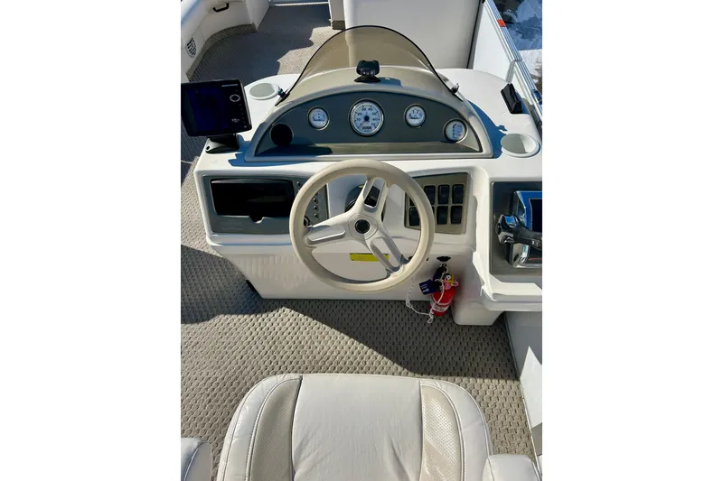 Slide: The Image of 2007 Crest LE 2270 boat dashboard with steering wheel and control panel. - 42