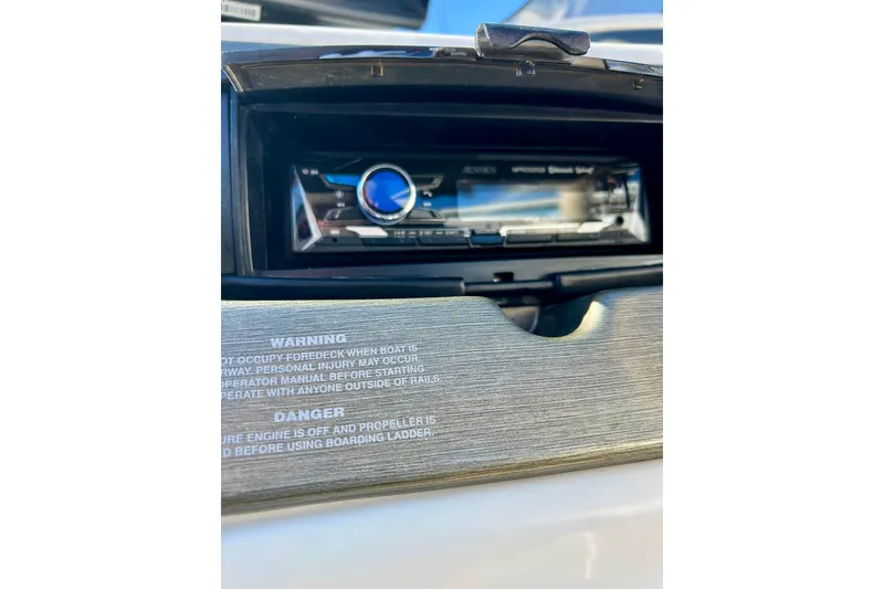 Slide: The Image of 2007 Crest LE 2270 boat dashboard with Jensen stereo and safety warnings. - 44