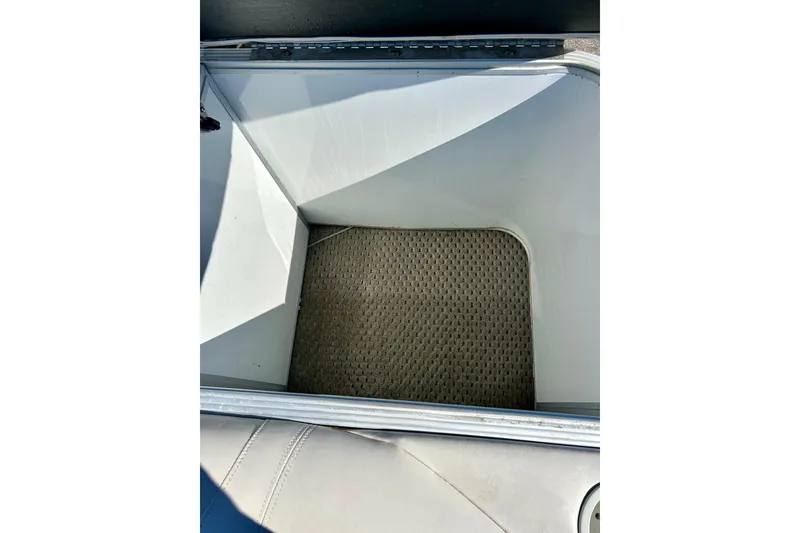 Slide: The Image of Storage compartment of 2007 Crest LE 2270 boat with carpeted interior. - 49