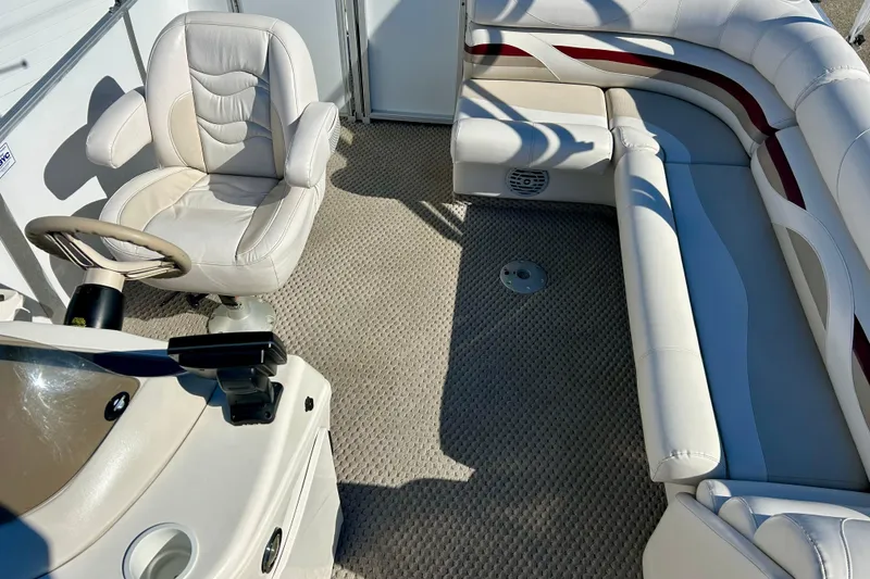 Slide: The Image of Interior of a 2007 Crest LE 2270 boat with plush seating and steering wheel. - 50