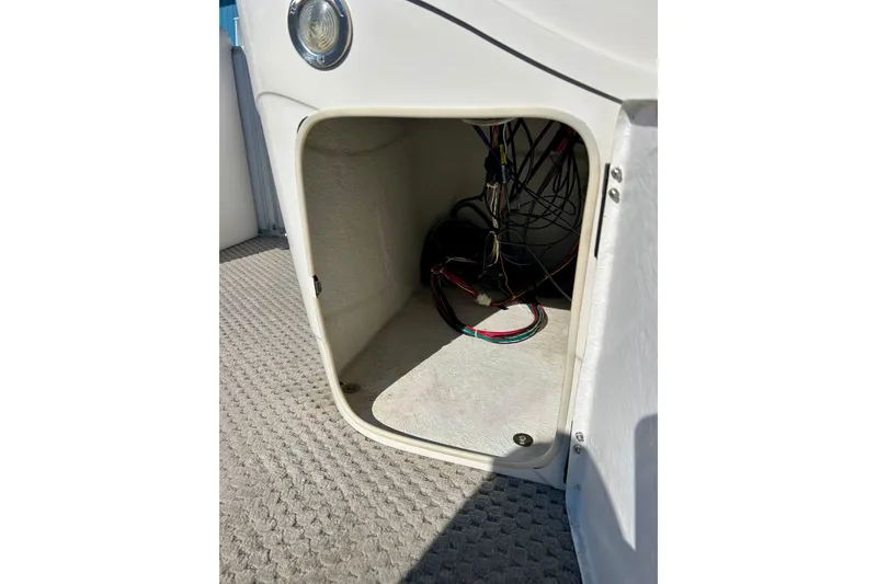 Slide: The Image of Open storage compartment with wiring inside a 2007 Crest LE 2270 boat. - 52