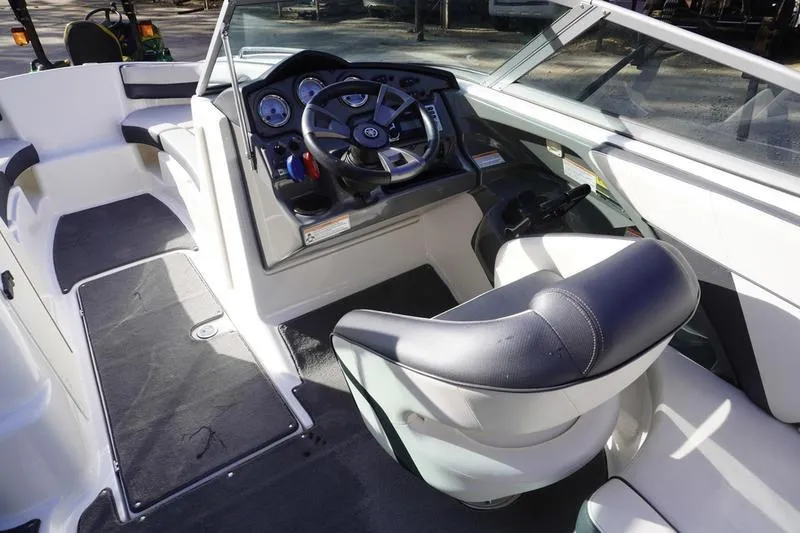 Slide: The Image of 2015 Yamaha Boats SX210 interior with steering wheel and seating. - 16