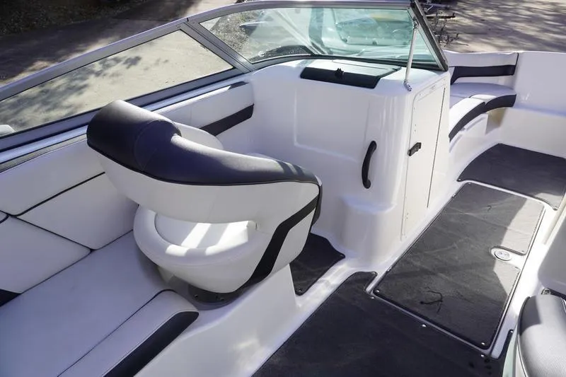 Slide: The Image of 2015 Yamaha Boats SX210 interior with seating and steering area, featuring sleek design and comfort. - 21