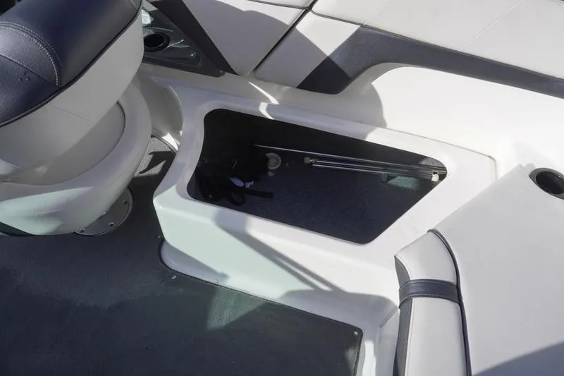 Slide: The Image of 2015 Yamaha Boats SX210 interior storage compartment with seating and accessories. - 25