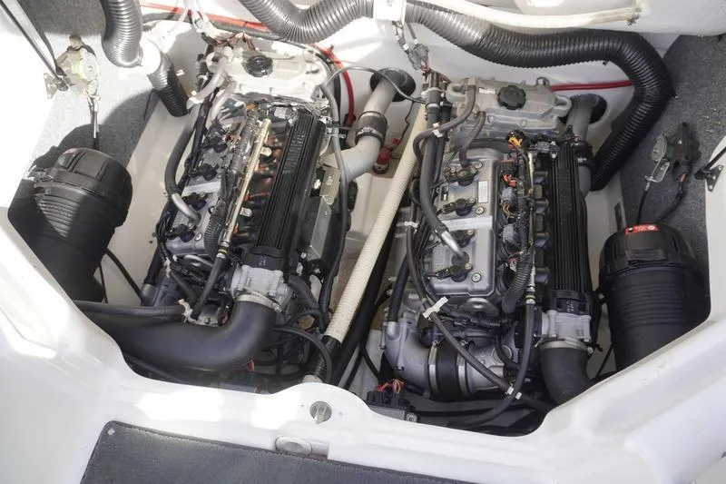 Slide: The Image of 2015 Yamaha Boats SX210 engine compartment with dual engines and wiring. - 29