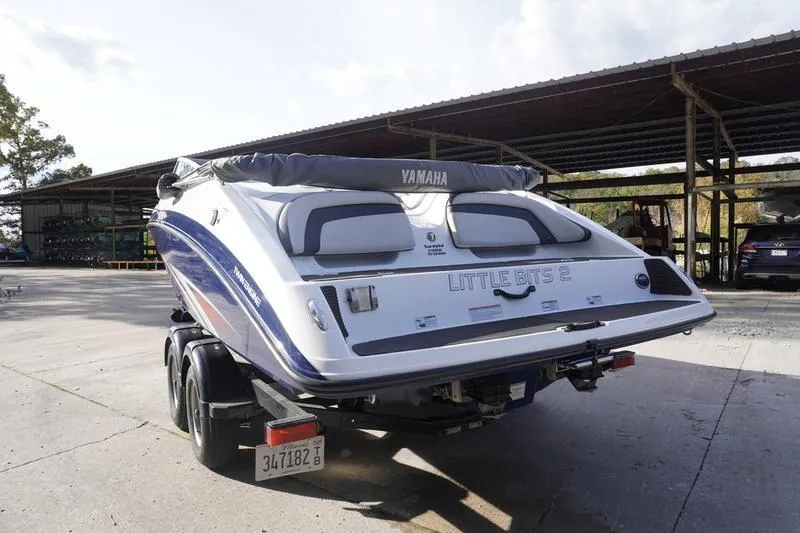 Slide: The Image of 2015 Yamaha Boats SX210 on trailer, parked outdoors under a canopy. - 3