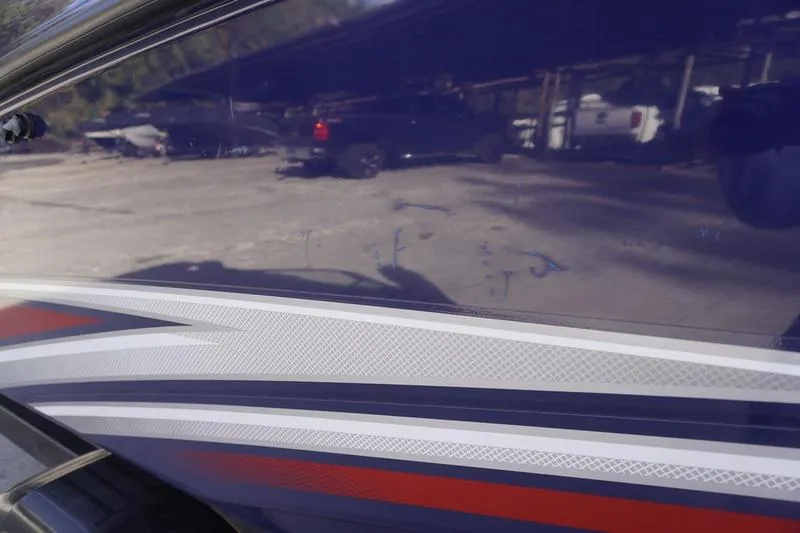 Slide: The Image of 2015 Yamaha Boats SX210 with sleek blue and red detailing. - 30