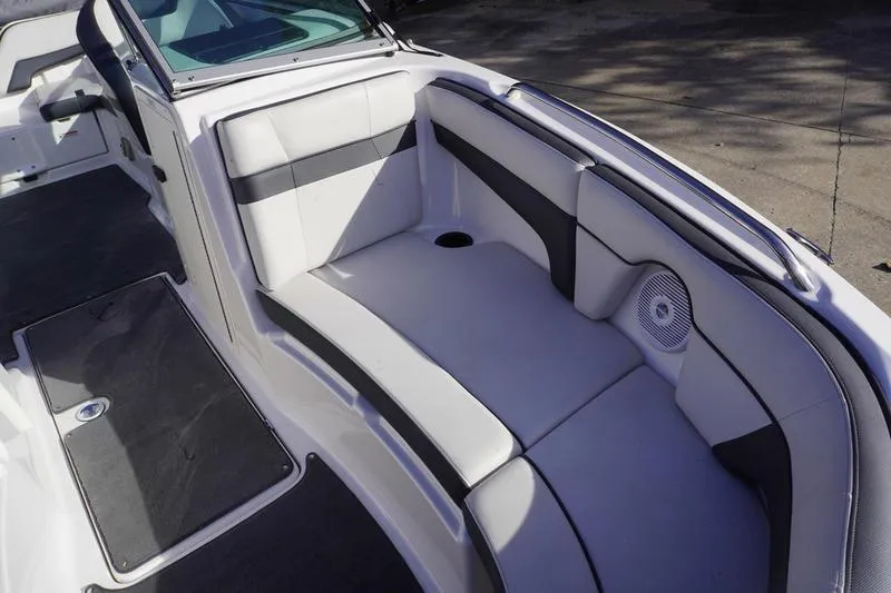Slide: The Image of 2015 Yamaha Boats SX210 interior seating with white and gray upholstery. - 7
