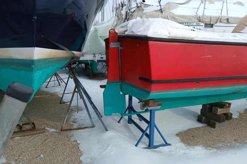 Slide: The Image of Boats in winter storage, including a 1948 Burt Bros model 26, covered in snow. - 2