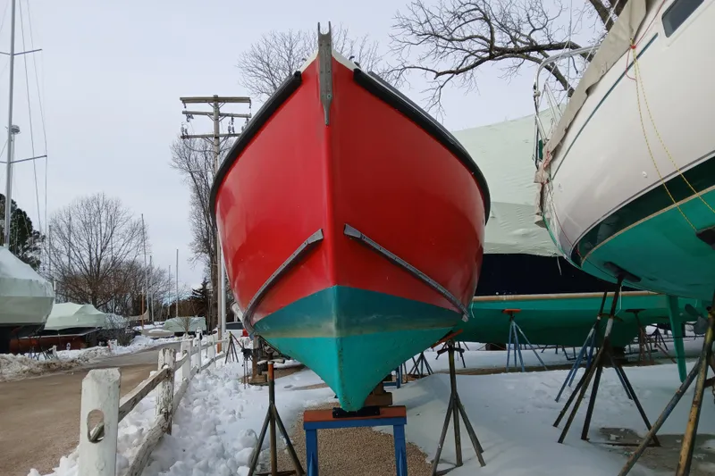 Slide: The Image of Red and turquoise 1948 Burt Bros 26 boat on stands in snowy yard. - 3