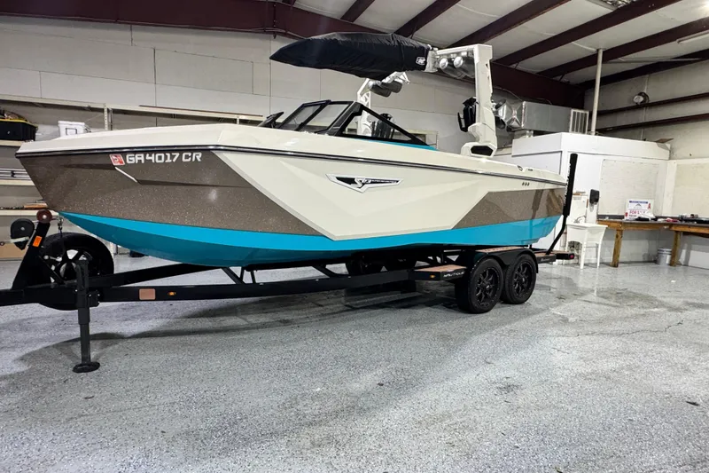 The Image of 2023 Nautique Super Air Nautique S23 boat on trailer in indoor storage. - 0