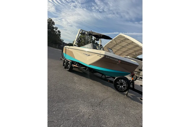 Slide: The Image of 2023 Nautique Super Air Nautique S23 boat on trailer in indoor storage. - 1
