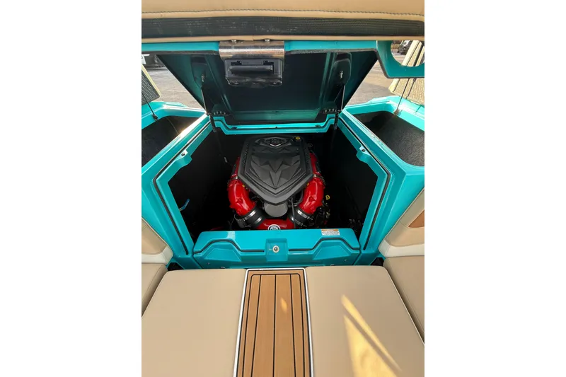 Slide: The Image of 2023 Nautique Super Air Nautique S23 interior with beige seating and wood accents. - 10