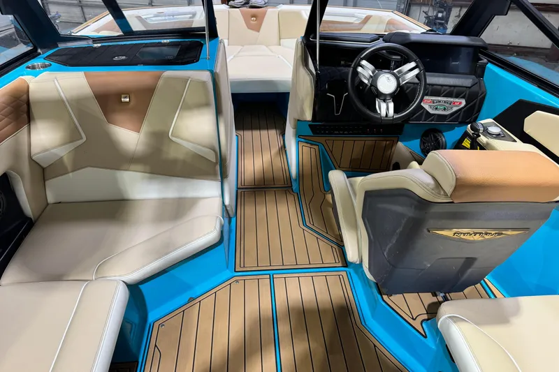 Slide: The Image of 2023 Nautique Super Air Nautique S23 interior with blue accents and luxurious seating. - 12