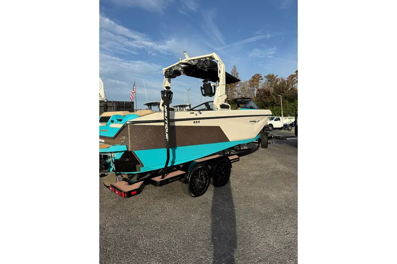 Slide: The Image of 2023 Nautique Super Air Nautique S23 boat on trailer in indoor storage facility. - 2