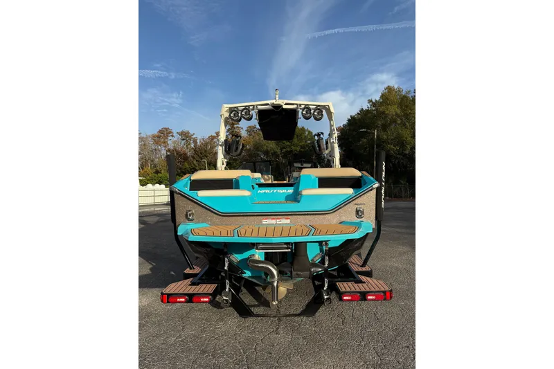 Slide: The Image of 2023 Nautique Super Air Nautique S23 boat in a warehouse setting. - 3