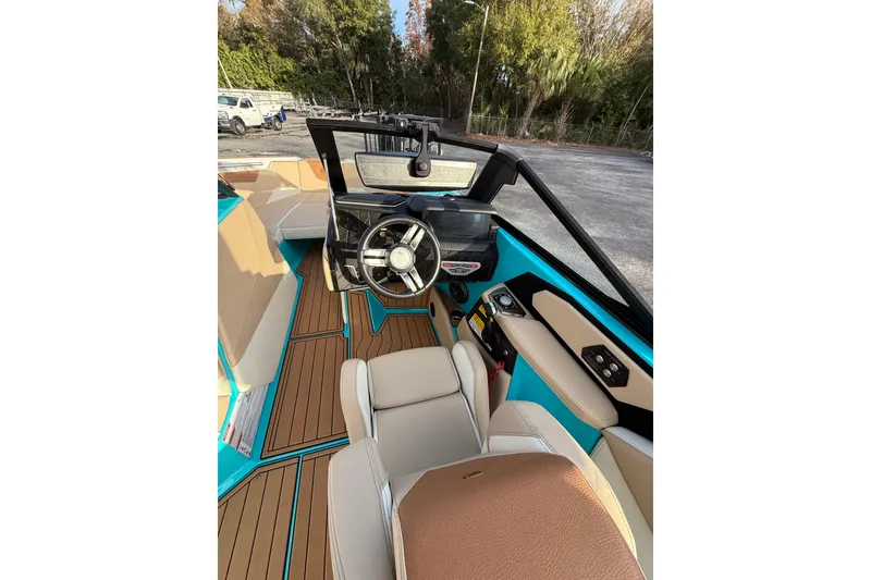 Slide: The Image of 2023 Nautique Super Air Nautique S23 interior with tan and blue accents. - 8