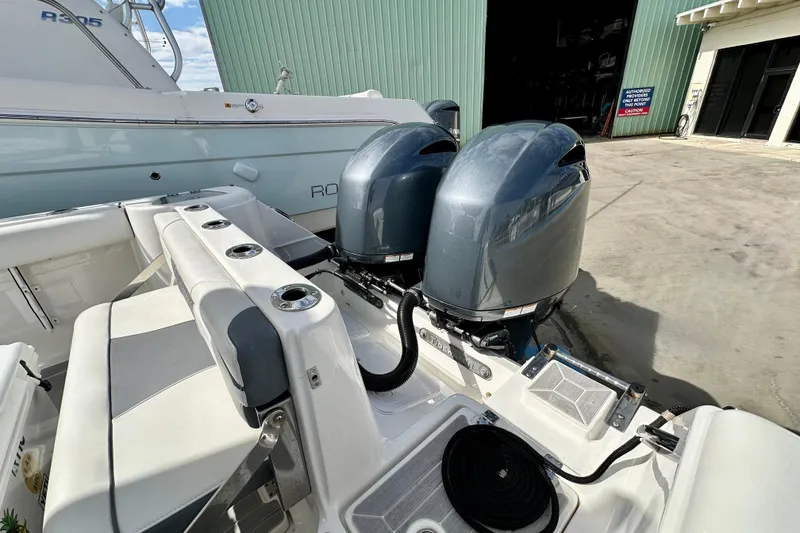 Slide: The Image of 2019 Tidewater 252 CC Adventure boat cruising on sunny blue waters. - 10