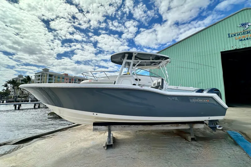 Slide: The Image of 2019 Tidewater 252 CC Adventure boat cruising on a sunny day. - 2