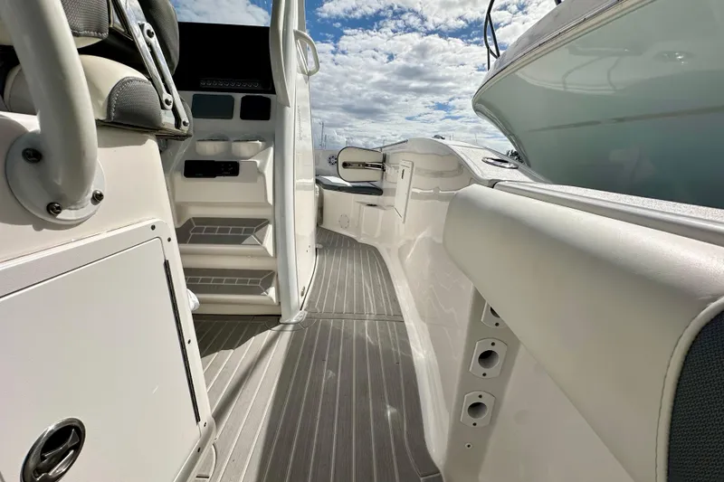 Slide: The Image of 2019 Tidewater 252 CC Adventure boat on trailer, blue sky background. - 20