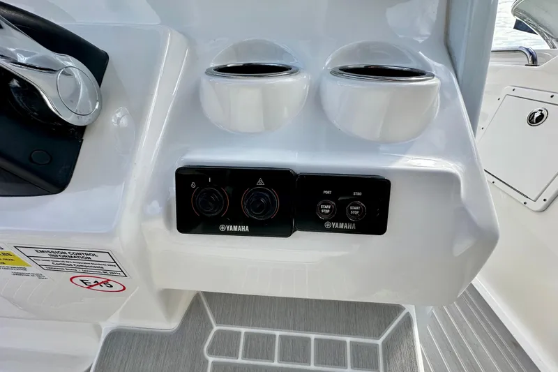 Slide: The Image of 2019 Tidewater 252 CC Adventure boat with dual outboard motors at a marina. - 24