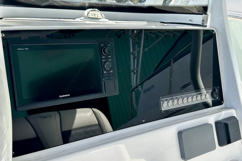 Slide: The Image of 2019 Tidewater 252 CC Adventure boat with dual outboard motors at a marina. - 25