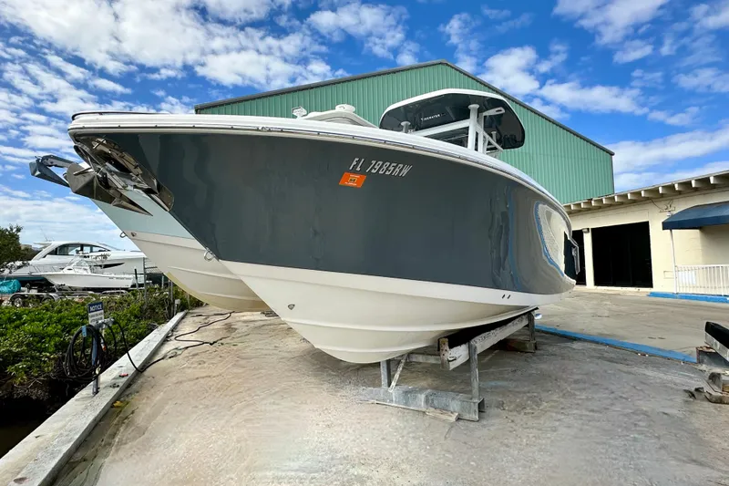 Slide: The Image of 2019 Tidewater 252 CC Adventure boat cruising on sparkling blue water. - 3