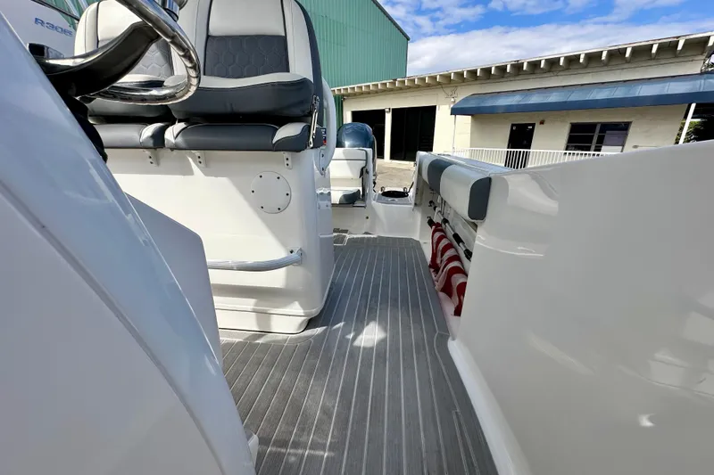 Slide: The Image of 2019 Tidewater 252 CC Adventure boat interior with seating and steering wheel. - 46