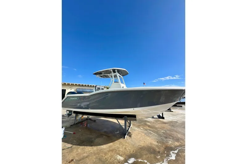 Slide: The Image of 2019 Tidewater 252 CC Adventure boat cruising on open blue water. - 5