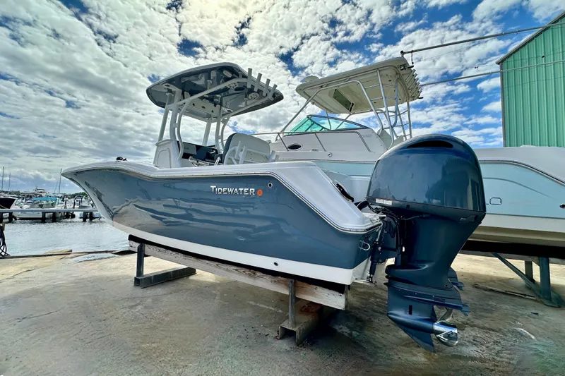 Slide: The Image of 2019 Tidewater 252 CC Adventure boat cruising on a sunny day in open water. - 9