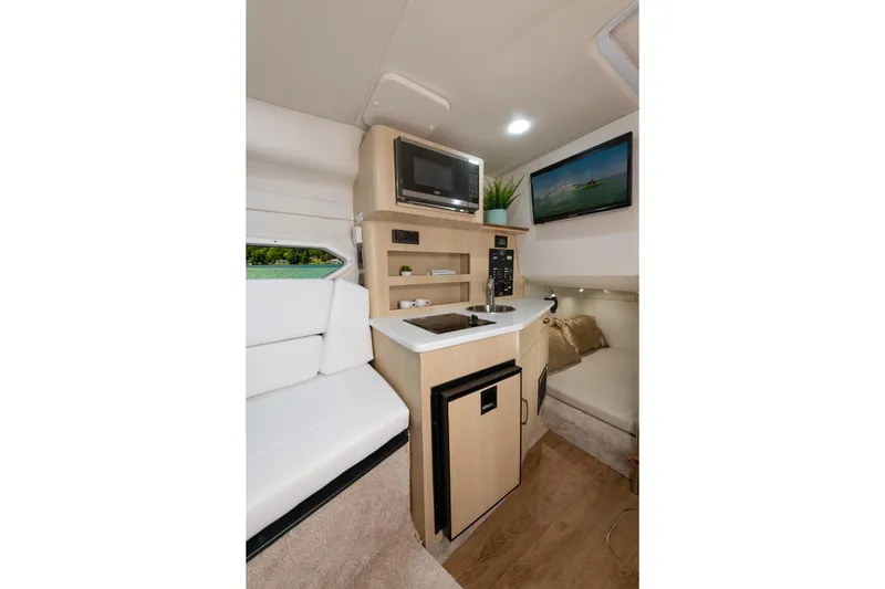 Slide: The Image of Interior of 2016 Regal 28 Express boat with kitchenette and seating area. - 6