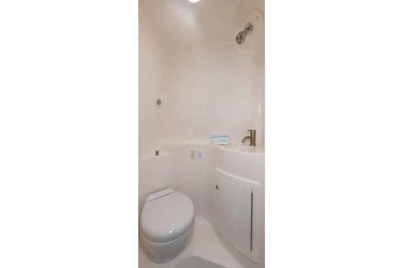 Slide: The Image of Compact bathroom in 2016 Regal 28 Express boat with modern fixtures. - 8