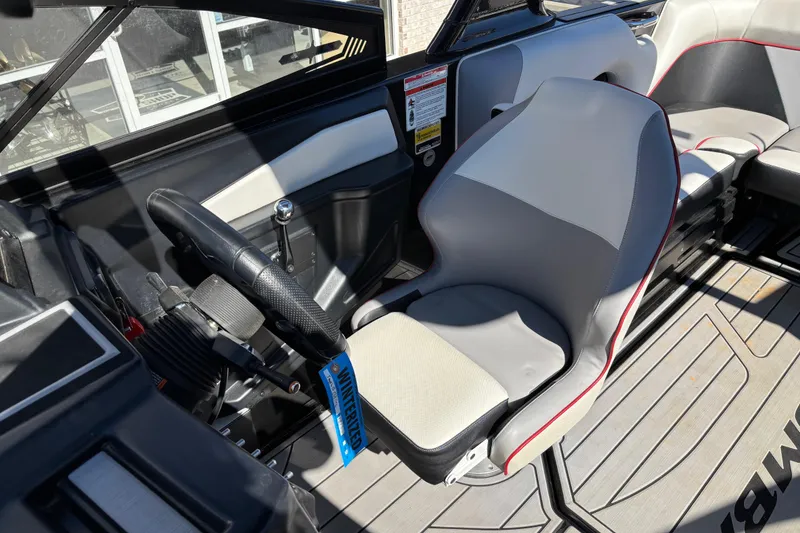 Slide: The Image of 2020 Moomba Craz boat interior with steering wheel and seating area. - 11