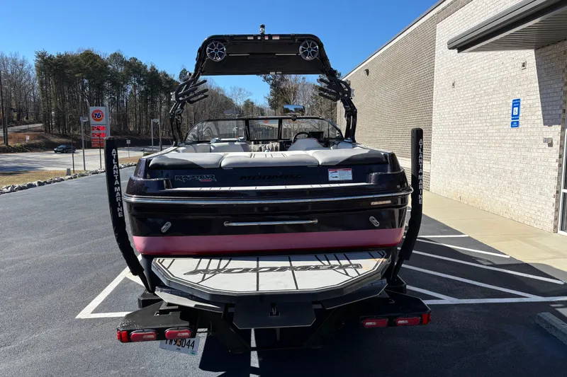 Slide: The Image of 2020 Moomba Craz boat parked outside, rear view with wakeboard tower. - 3