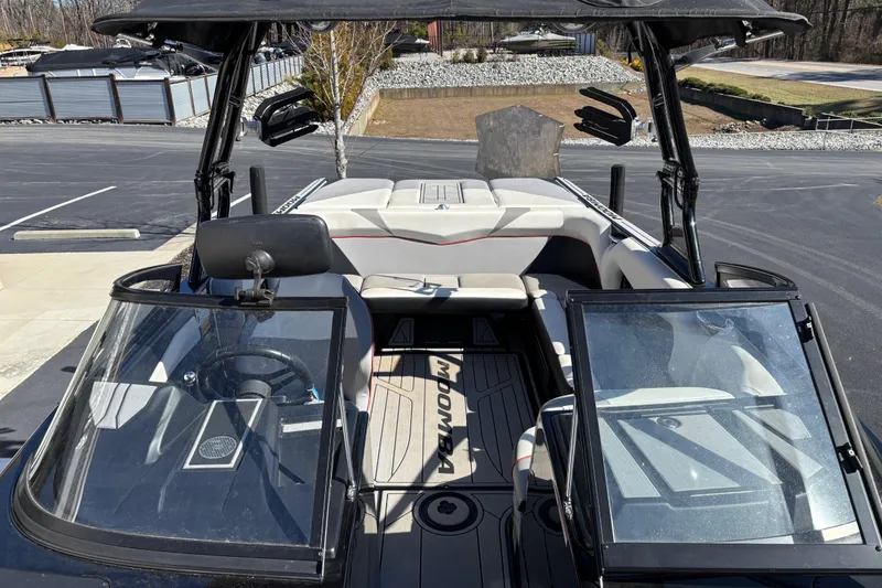 Slide: The Image of 2020 Moomba Craz boat interior with open windshield, showcasing seating and steering area. - 7