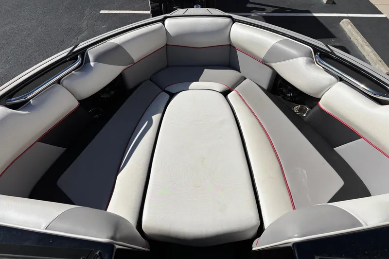 Slide: The Image of 2020 Moomba Craz boat interior with gray seating and red accents. - 8