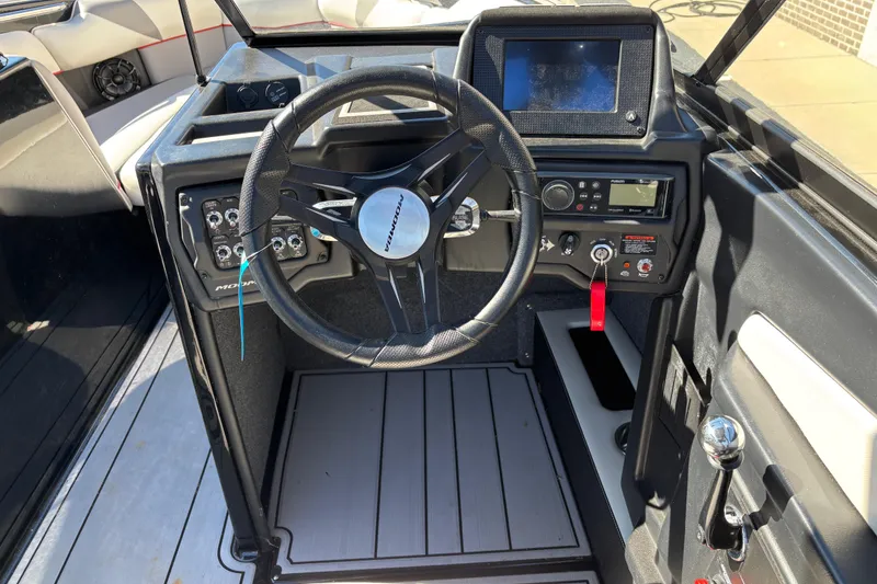 Slide: The Image of 2020 Moomba Craz boat dashboard with steering wheel and control panel. - 9