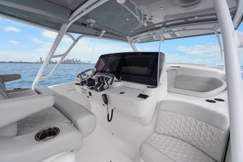 Slide: The Image of 2024 Intrepid 41 Valor boat interior with modern helm and seating, ocean view. - 11