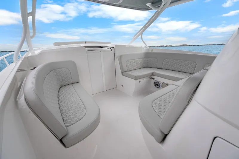 Slide: The Image of 2024 Intrepid 41 Valor boat interior with luxurious seating and ocean view. - 12