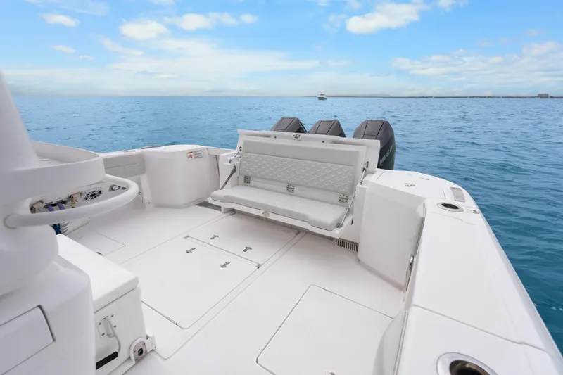 Slide: The Image of 2024 Intrepid 41 Valor boat deck with seating, ocean view, and clear sky. - 15
