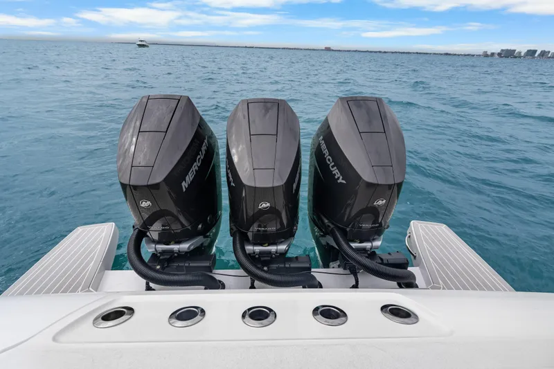 Slide: The Image of Triple Mercury outboard engines on a 2024 Intrepid 41 Valor boat in open water. - 16