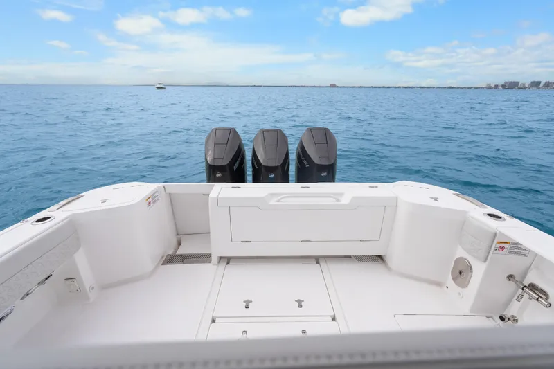 Slide: The Image of 2024 Intrepid 41 Valor boat with triple outboard engines on open sea. - 17