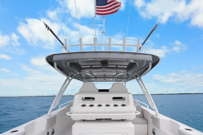 Slide: The Image of 2024 Intrepid 41 Valor boat with American flag, open sea, and clear sky. - 18
