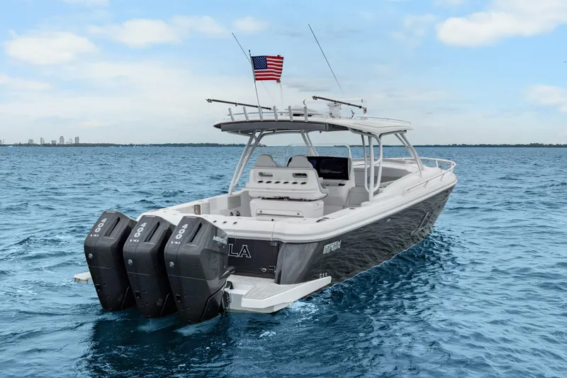 Slide: The Image of 2024 Intrepid 41 Valor boat with triple Mercury engines on open water. - 2