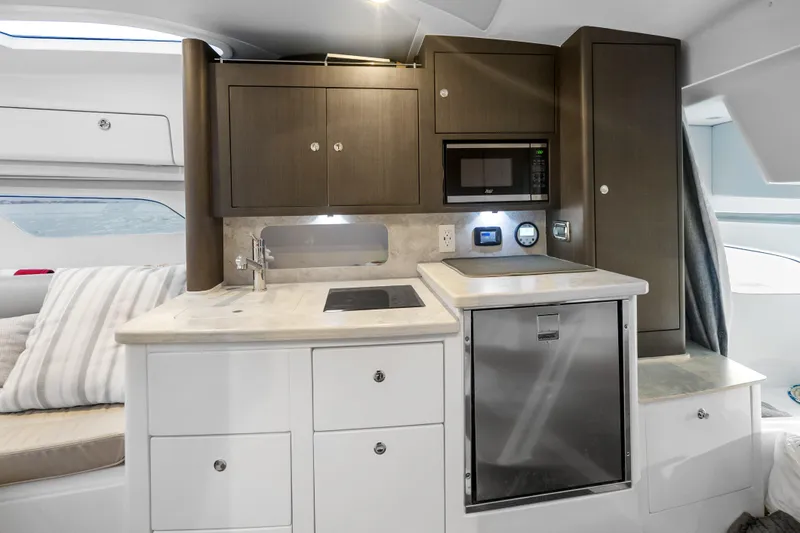 Slide: The Image of 2024 Intrepid 41 Valor yacht interior kitchen with modern appliances and sleek cabinetry. - 20