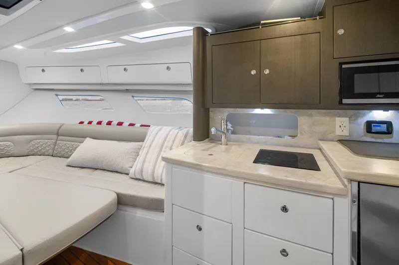 Slide: The Image of Luxurious interior of 2024 Intrepid 41 Valor yacht with modern kitchenette and seating area. - 21